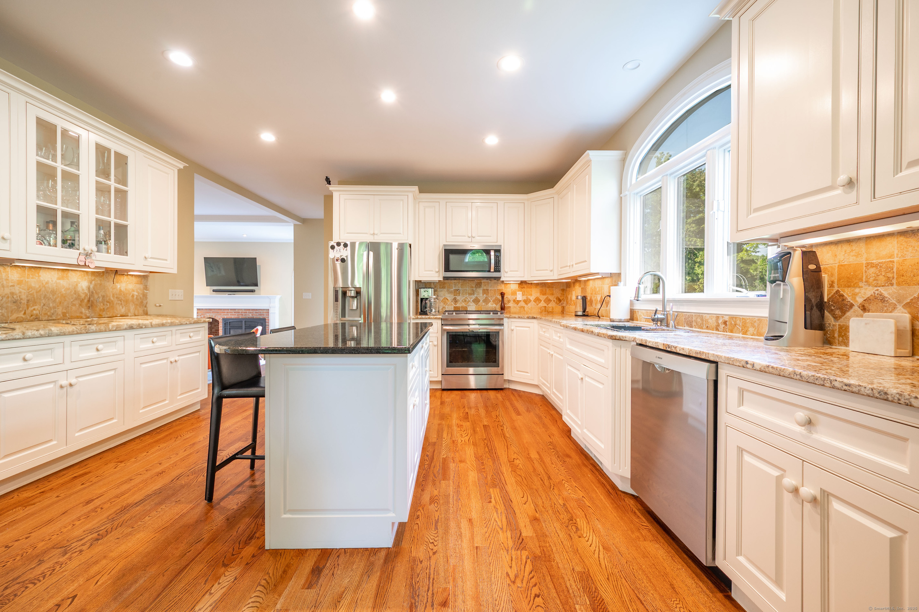 64 River Ford Road Brookfield, CT 06804 - Photo 5 of 28 a kitchen with stainless steel appliances granite countertop a refrigerator a stove top oven a sink and dishwasher with wooden floor
