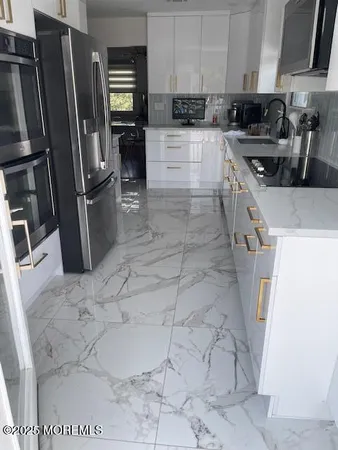a kitchen with a sink stainless steel appliances and cabinets