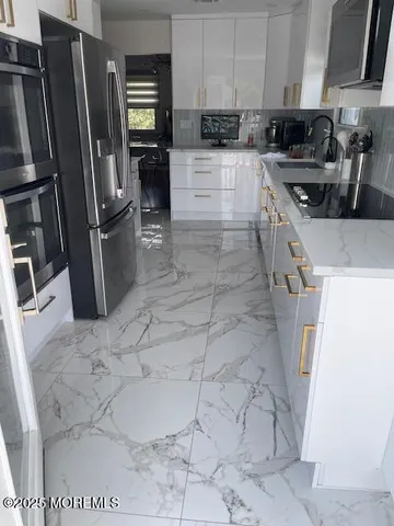a kitchen with a sink stainless steel appliances and cabinets