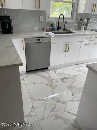 a kitchen with a sink and a stove top oven
