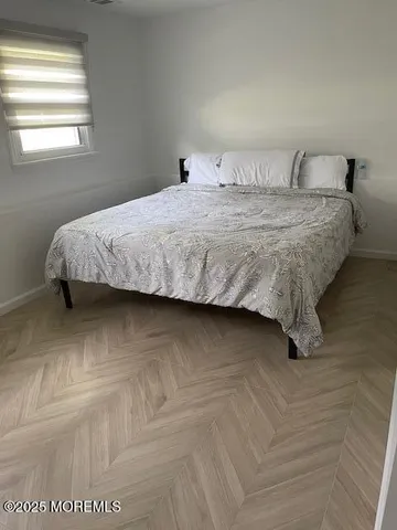 a bedroom with a bed and window