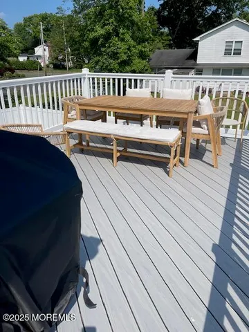 a roof deck with a table and chairs