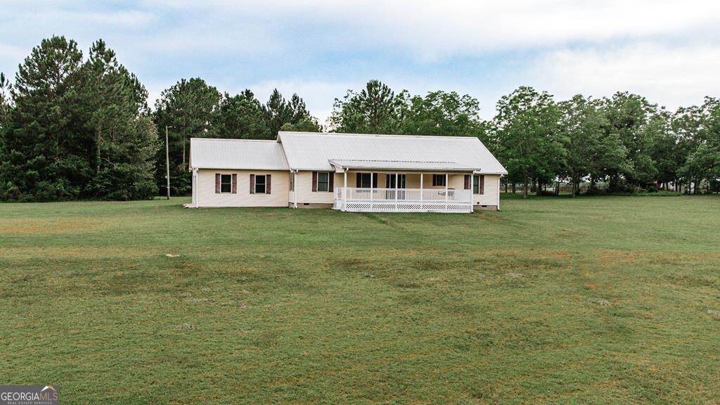 1272 Hopewell Road Ashburn, GA 31714 - Photo 1 of 1 an aerial view of residential houses with outdoor space and trees