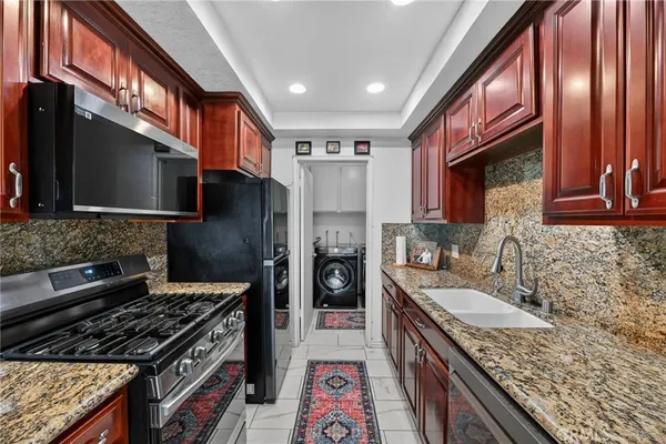 a kitchen with a stove sink and refrigerator