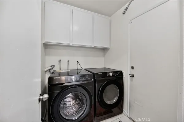 a utility room with sink dryer and washer