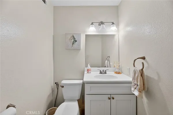 a bathroom with a sink toilet and a mirror