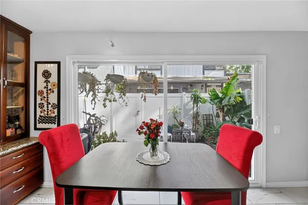 a view of a dining room with furniture and a potted plant