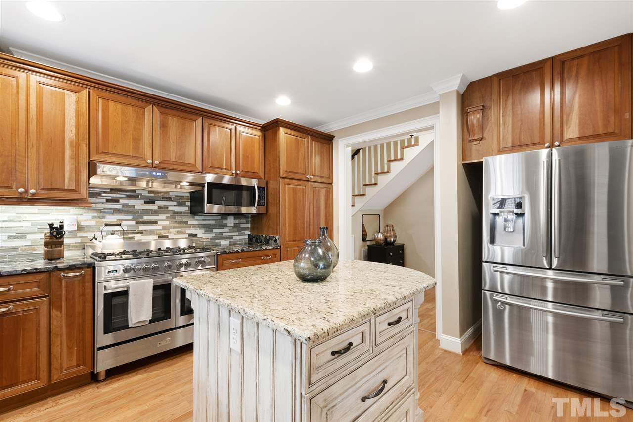 3712 Bellevue Road Raleigh, NC 27609 - Photo 11 of 30 Deep kitchen sink, glass front cabinet doors, roll out windows, soft close drawers, can lighting, stainless steel appliances - Samsung dishwasher, refrigerator and microwave. Granite counter tops.