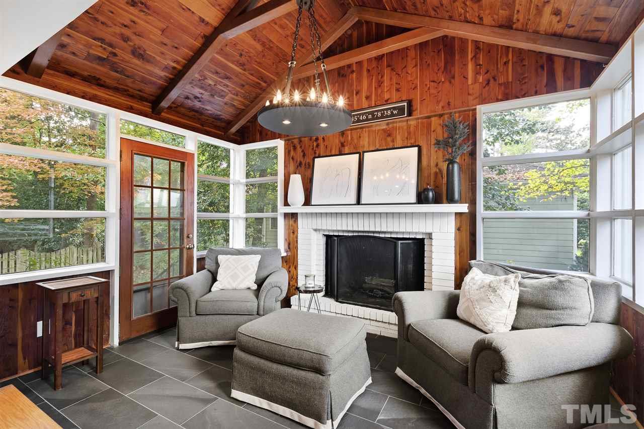 3712 Bellevue Road Raleigh, NC 27609 - Photo 12 of 30 Porcelain slate floor tiles, built-in book cases, knotty pine, wood burning fireplace, lots of natural light and exterior access. This room shows off the unique mill work and architecture.