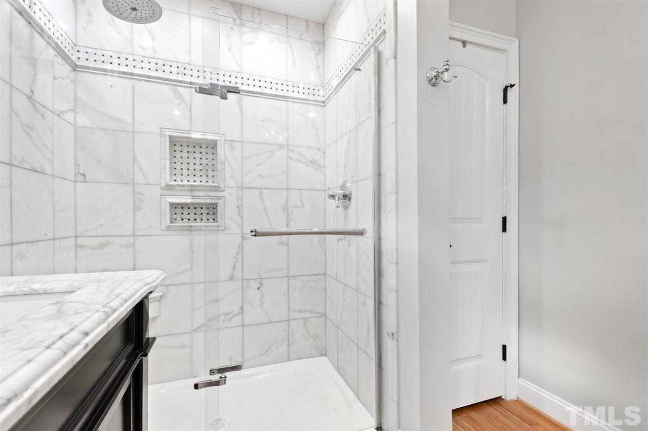 3712 Bellevue Road Raleigh, NC 27609 - Photo 18 of 30 Private water closet, double vanity with marble tile, tile flooring, over sized shower with rain shower head, linen closet and walk in closet.