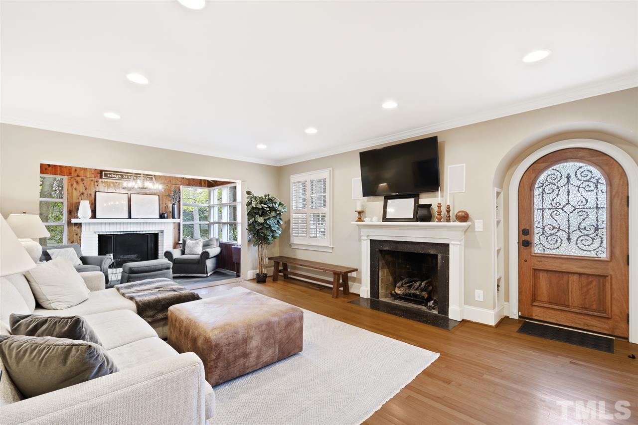 3712 Bellevue Road Raleigh, NC 27609 - Photo 5 of 30 The living room has a marble fireplace with Gas logs, prewired speakers, crown molding, plantation shutters, can lighting, hardwood flooring.