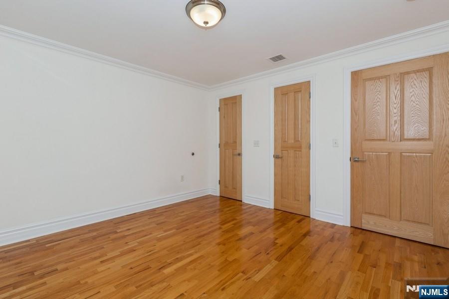 17 Meadow Road, Unit 405 Rutherford, NJ 07070 - Photo 9 of 18 a view of an empty room with wooden floor