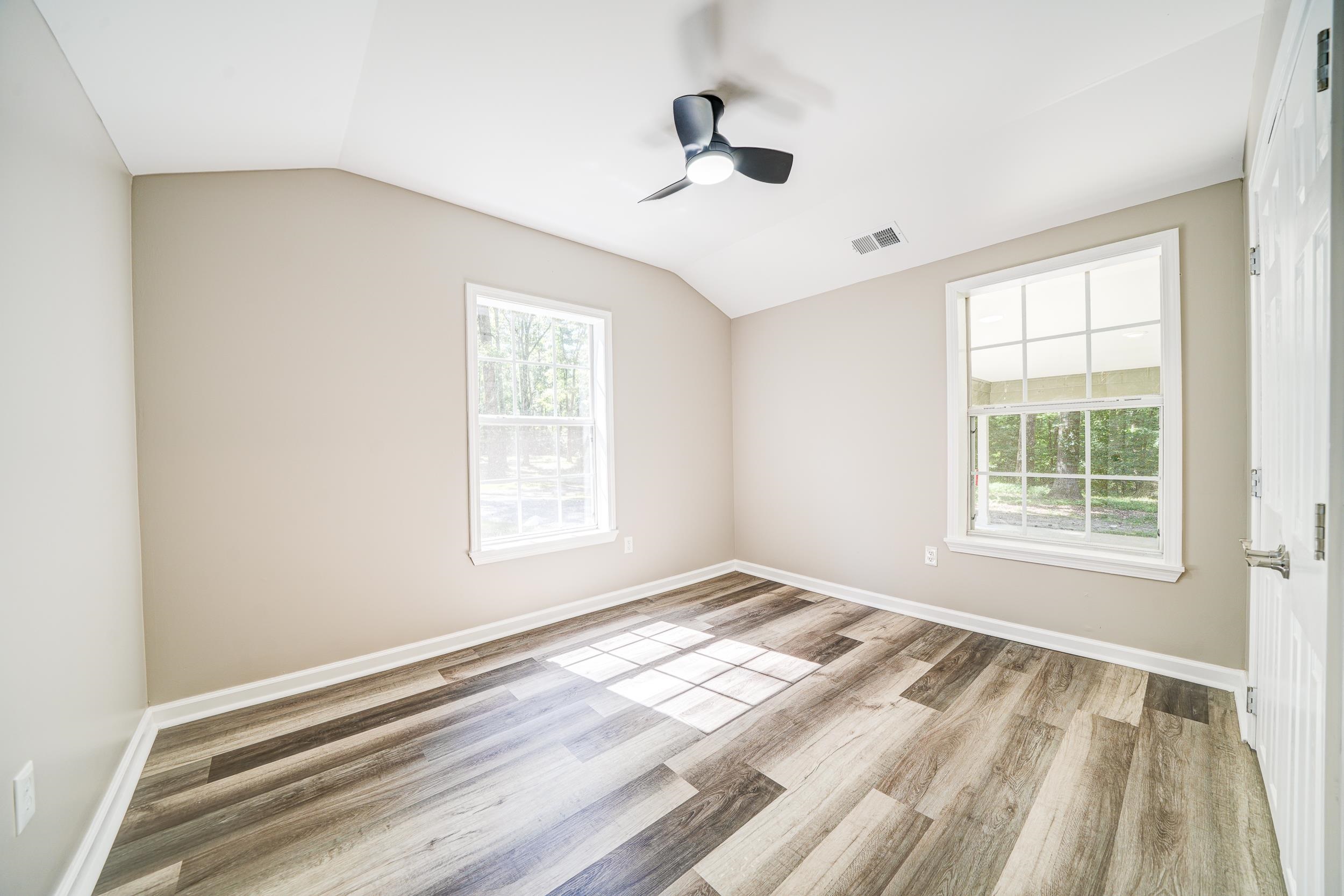 4630 Billy Maher Road Bartlett, TN 38135 - Photo 19 of 40 a view of an empty room with wooden floor and a window
