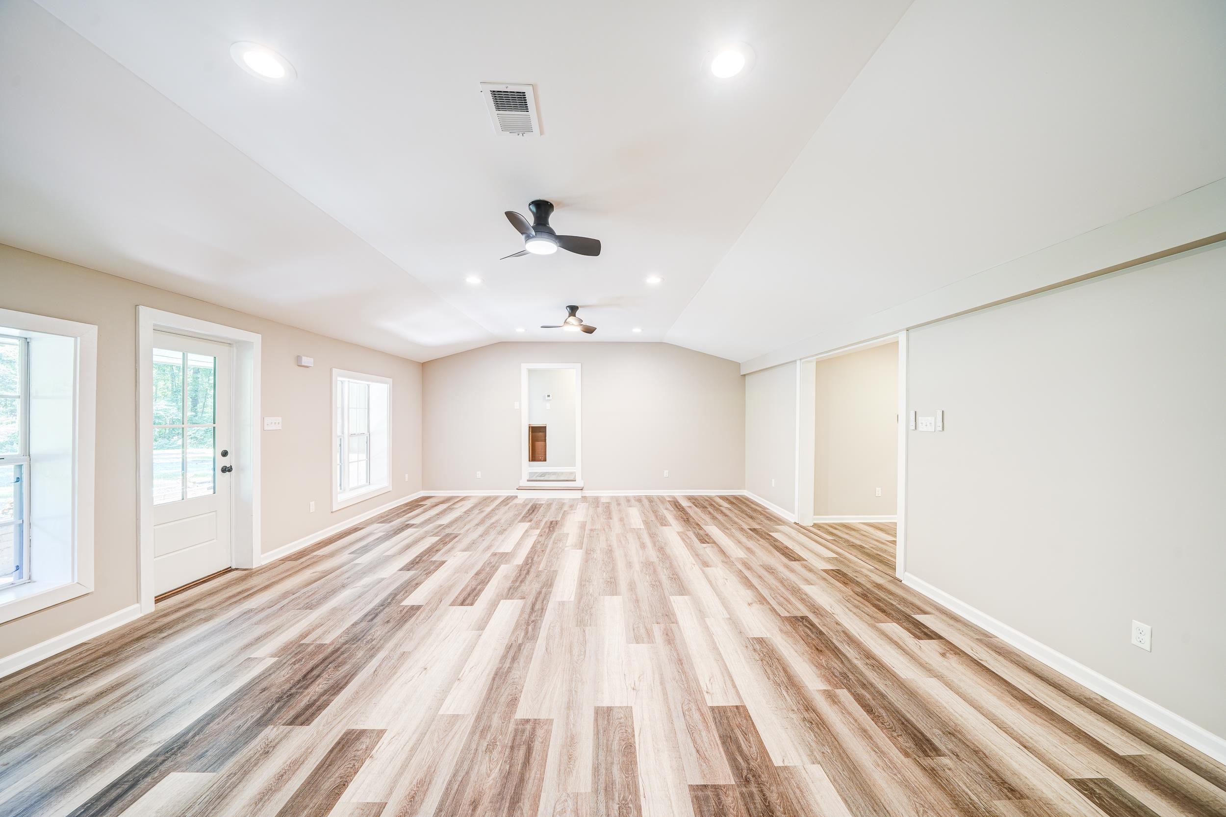 4630 Billy Maher Road Bartlett, TN 38135 - Photo 9 of 40 a view of an empty room with wooden floor and a window