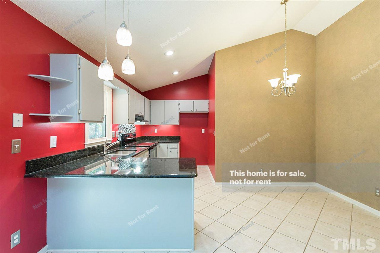 7809 Foxwood Drive Raleigh, NC 27615 - Photo 2 of 17 a kitchen with stainless steel appliances granite countertop a sink and a microwave