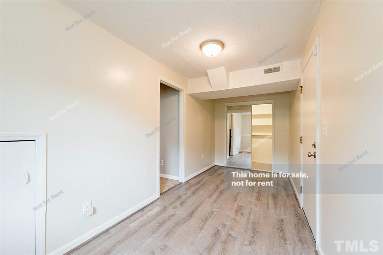 7809 Foxwood Drive Raleigh, NC 27615 - Photo 14 of 17 a view of a room with wooden floor and a bathroom