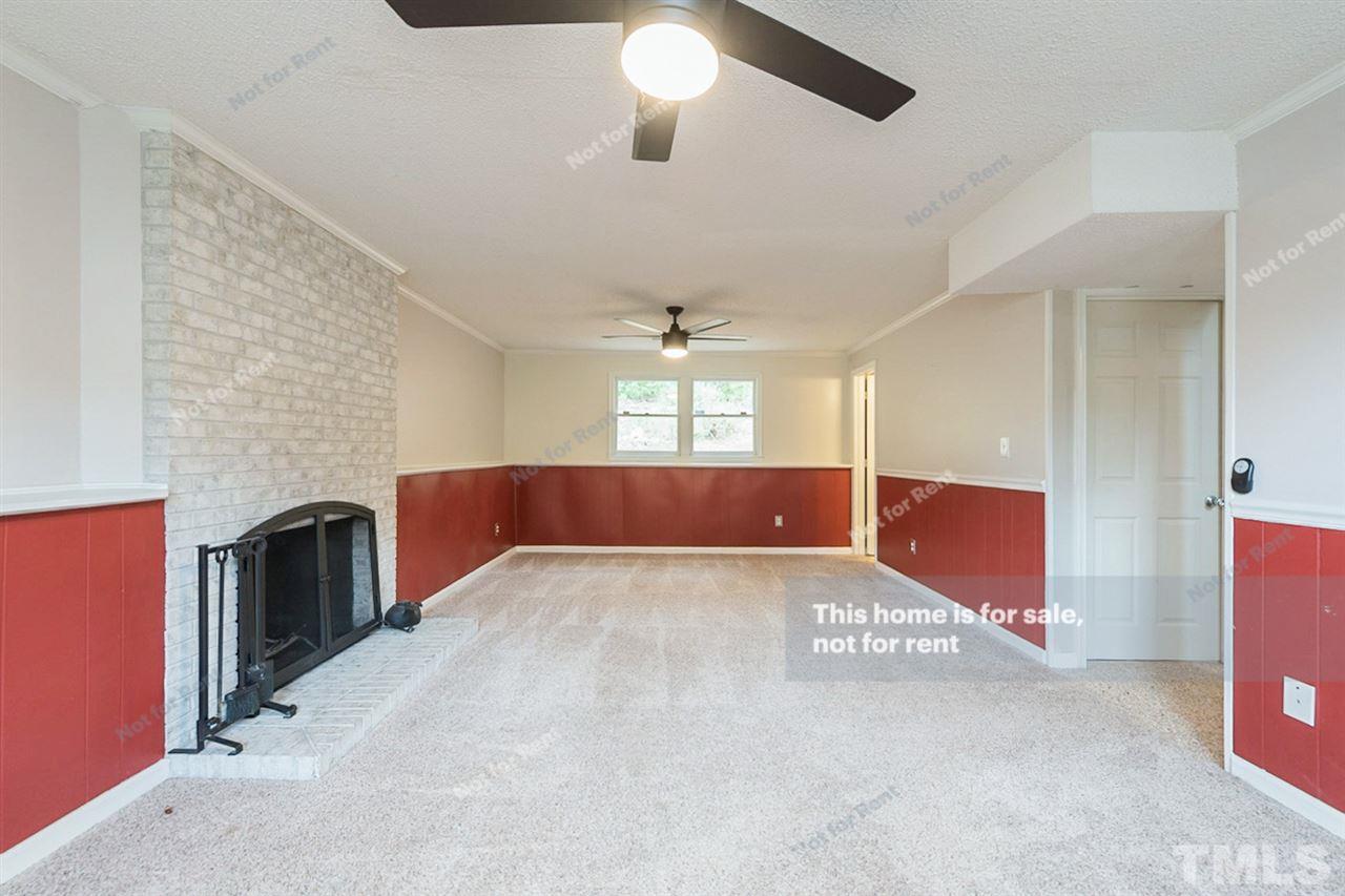 7809 Foxwood Drive Raleigh, NC 27615 - Photo 3 of 17 a view interior of a house with chandelier and fireplace