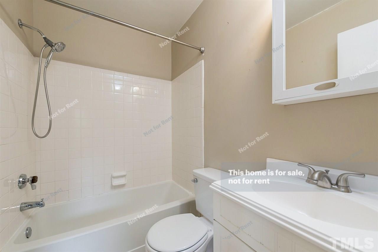 7809 Foxwood Drive Raleigh, NC 27615 - Photo 4 of 17 a bathroom with a granite countertop bathtub sink vanity mirror and toilet
