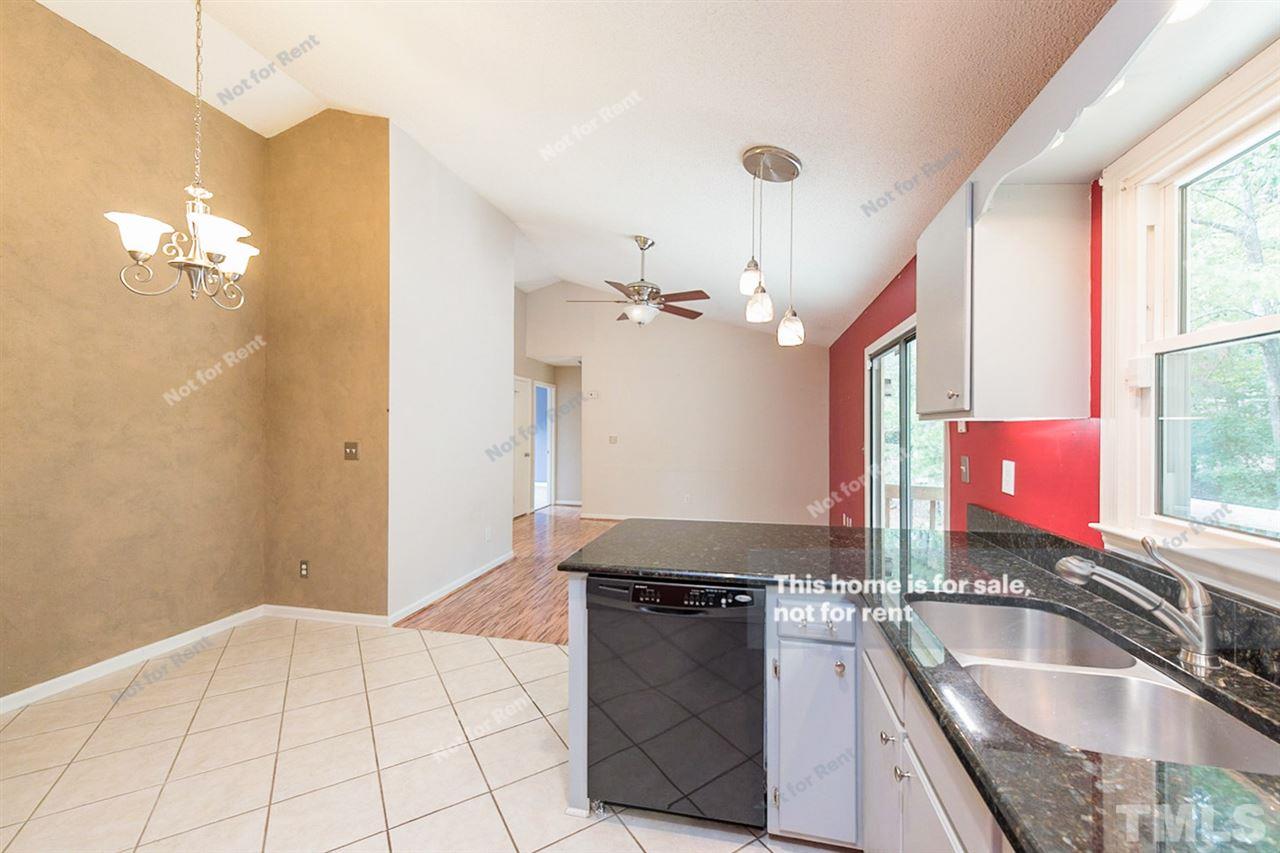 7809 Foxwood Drive Raleigh, NC 27615 - Photo 6 of 17 a kitchen with granite countertop a sink cabinets and window