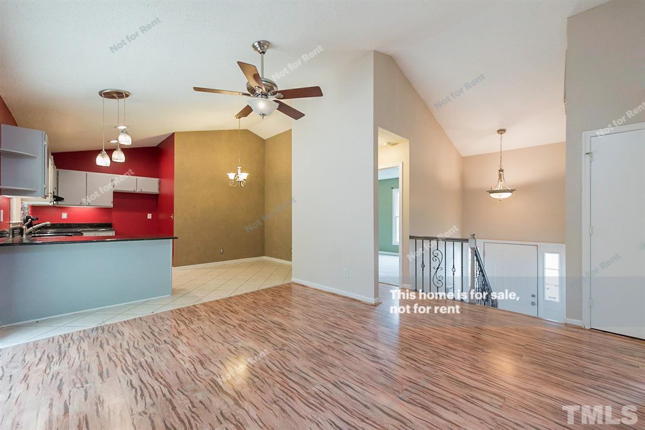 7809 Foxwood Drive Raleigh, NC 27615 - Photo 7 of 17 a view of an empty room and wooden floor