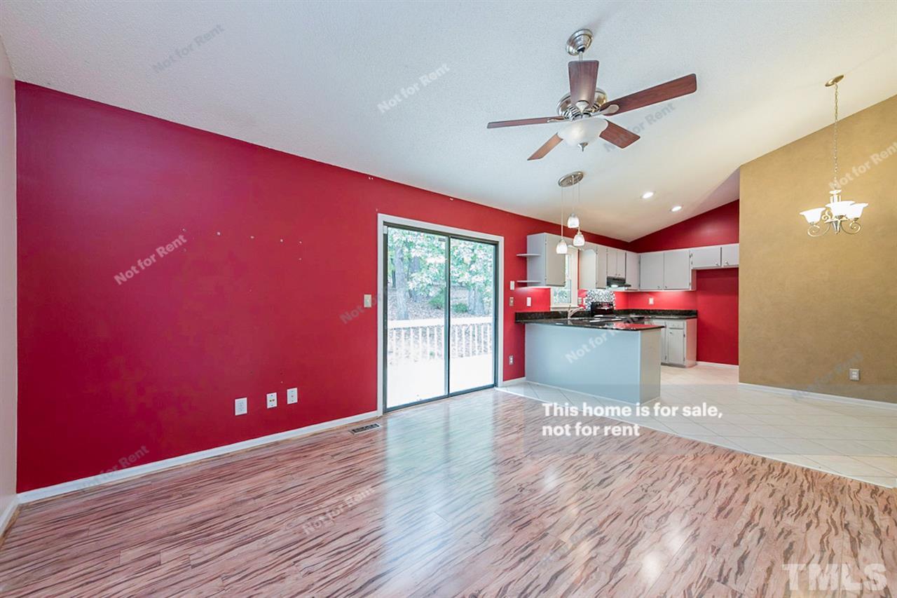 7809 Foxwood Drive Raleigh, NC 27615 - Photo 8 of 17 a big room with wooden floor and windows
