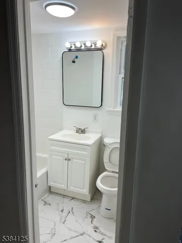 a view of a room with wooden floor and staircase