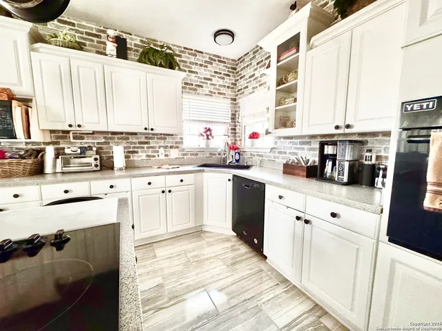 a kitchen with a sink stove and cabinets