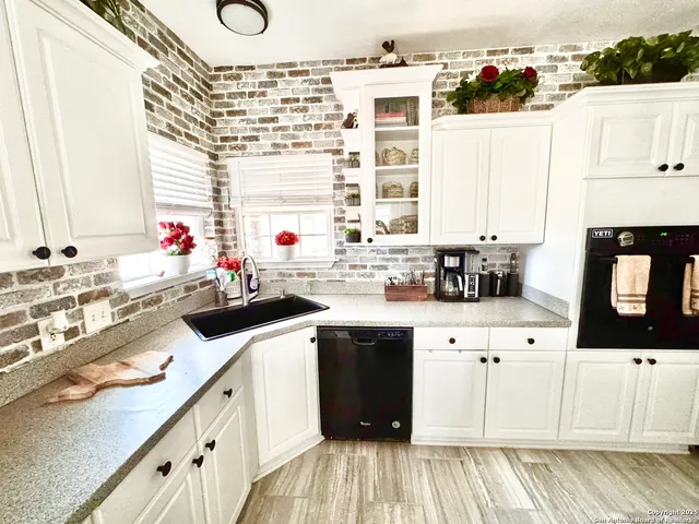 a kitchen with cabinets a sink and a stove