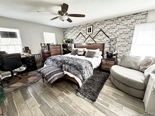 a bedroom with a bed couch and a window