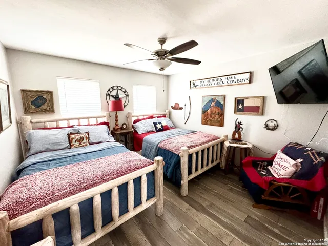 a bedroom with two beds and a window