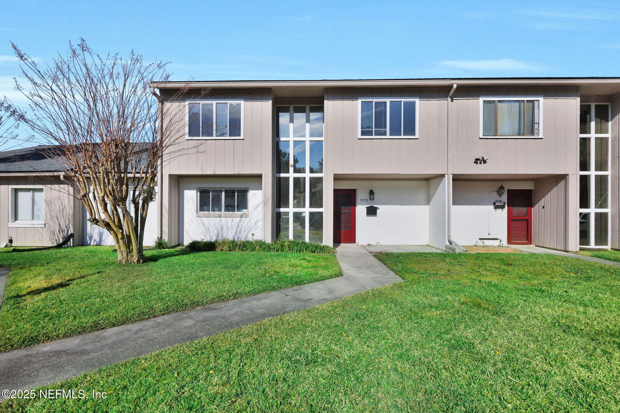 7170 Cypress Cove Road, Unit 28 Jacksonville, FL 32244 - Photo 1 of 22 a front view of a house with a yard