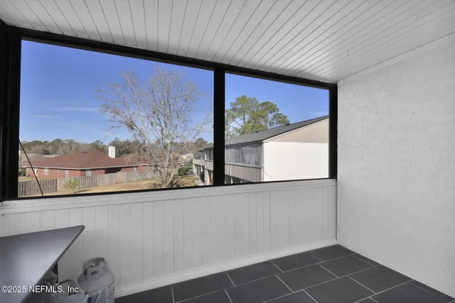 a bedroom with bed and a chandelier