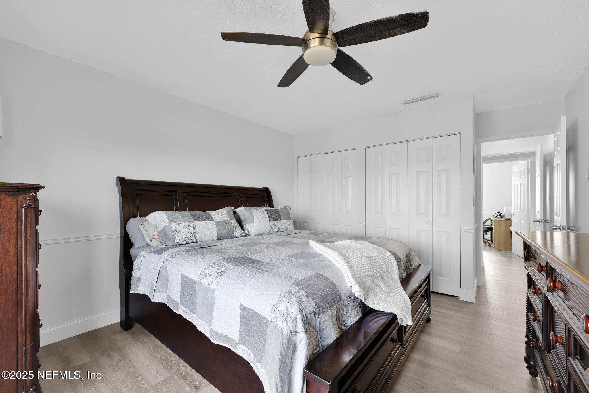 7170 Cypress Cove Road, Unit 28 Jacksonville, FL 32244 - Photo 19 of 22 a bedroom with bed and a chandelier