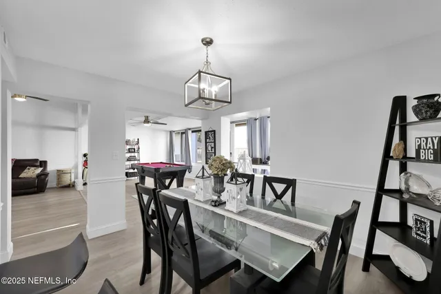 a living room with furniture pool table flat screen tv and a fireplace