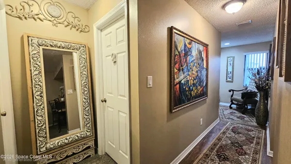 a view of a hallway with paintings on the walls