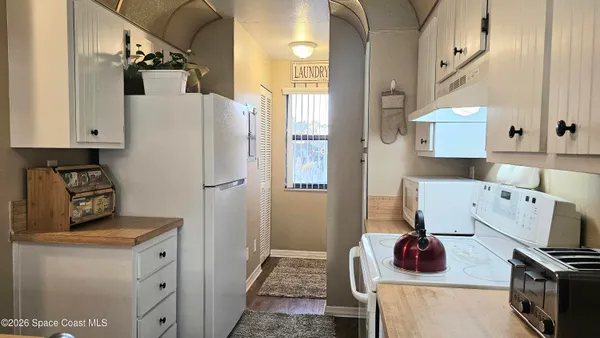 a kitchen with a refrigerator and a stove