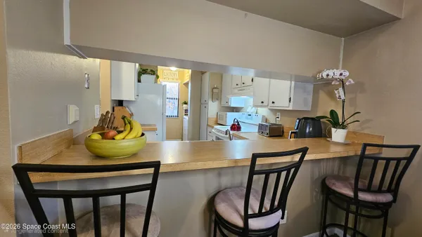 a view of a dining room with furniture and a chandelier