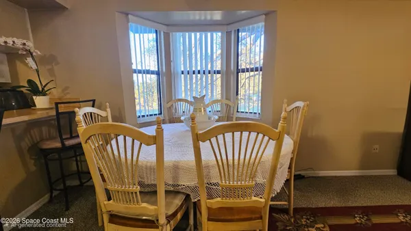 a view of a dining room with furniture window and outside view