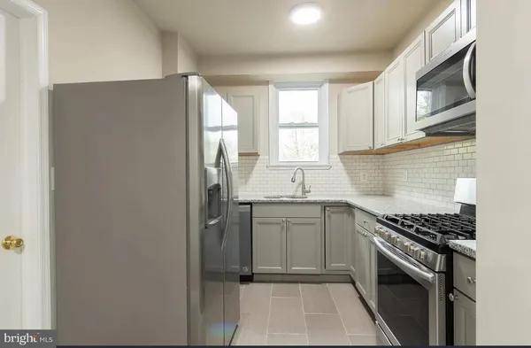 a kitchen with a sink stove and refrigerator