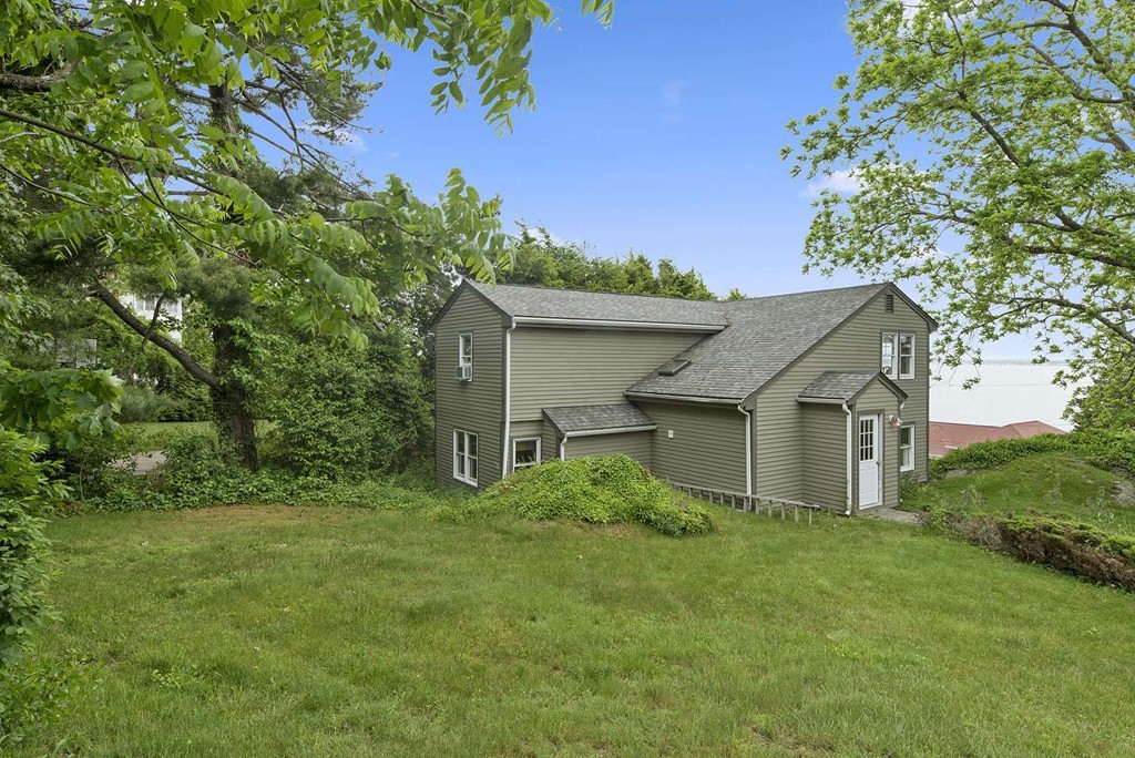 23 Crabtree Road Quincy, MA 02171 - Photo 18 of 20 a house with green field in front of it