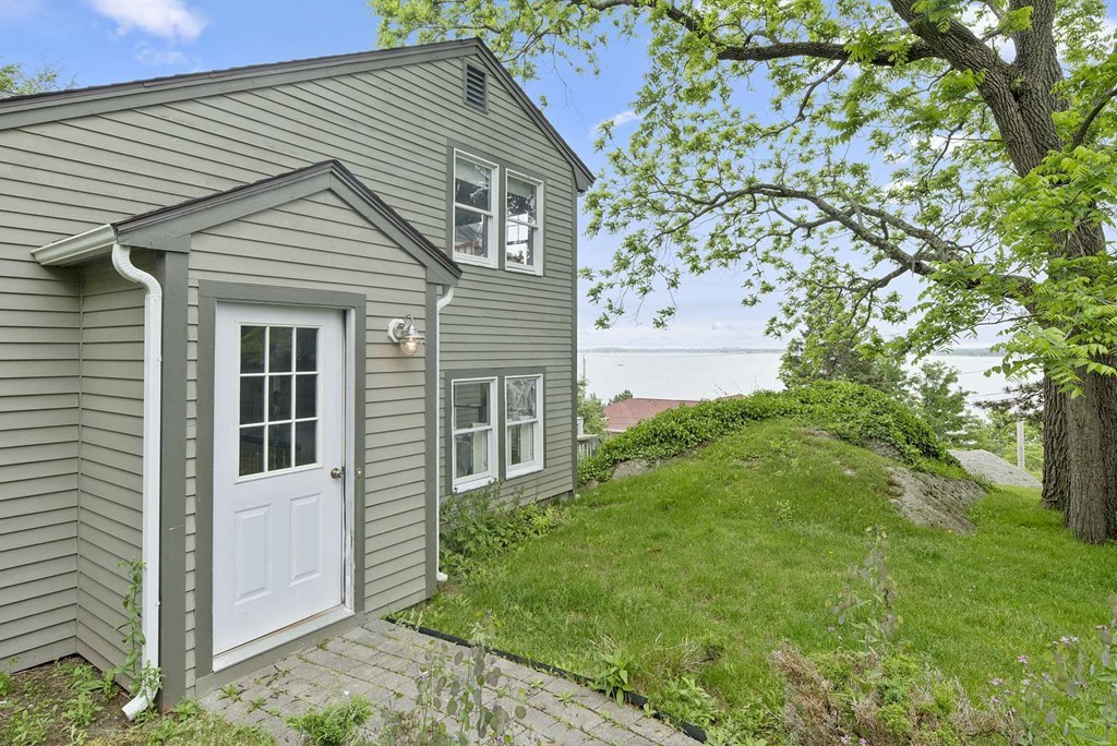23 Crabtree Road Quincy, MA 02171 - Photo 19 of 20 a backyard of a house with plants and large tree