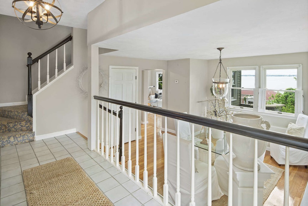 23 Crabtree Road Quincy, MA 02171 - Photo 9 of 20 a view of staircase with railing and a chandelier