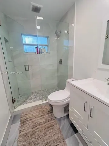 a bathroom with a toilet sink and shower