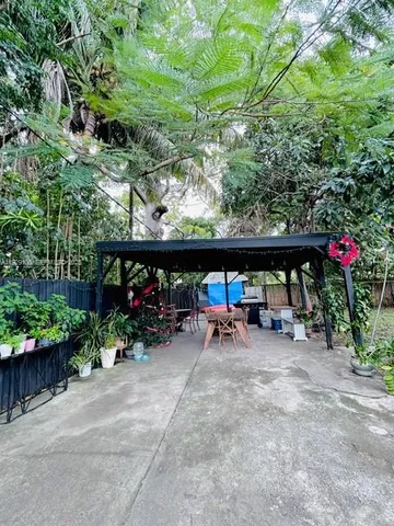 a view of a patio with table and chairs and potted plants