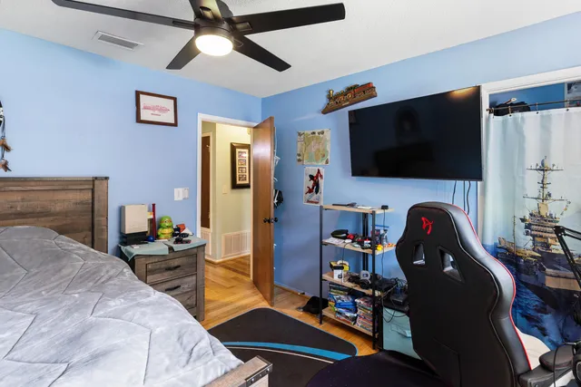 a bedroom with a bed and a flat screen tv