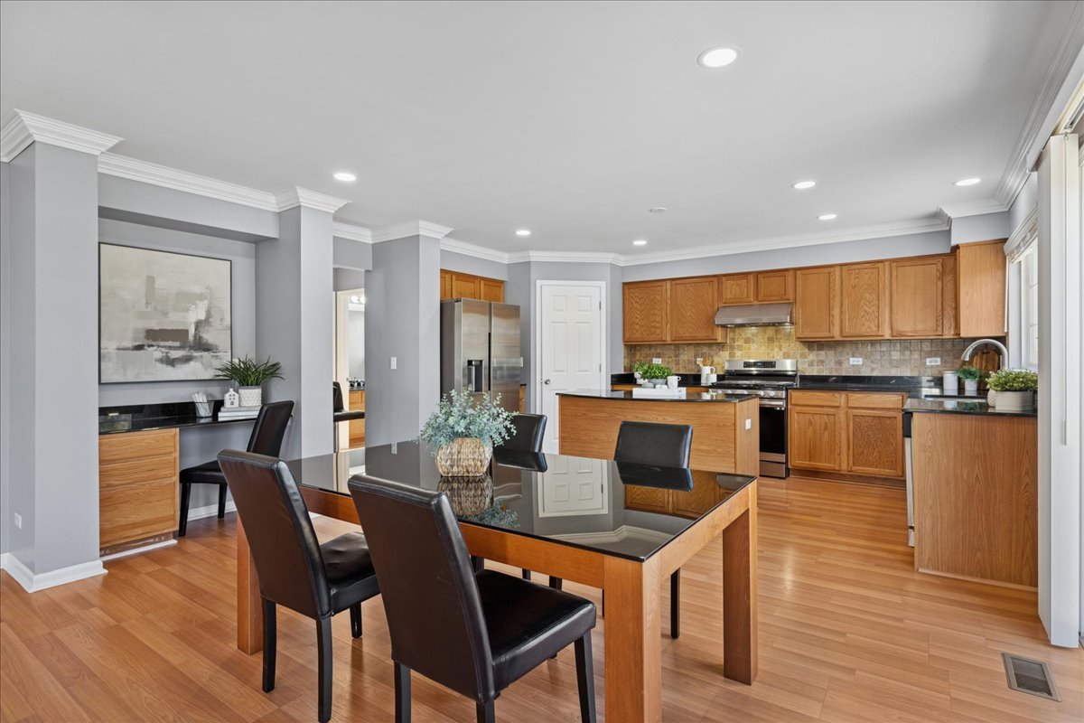 1480 Tudor Drive Mundelein, IL 60060 - Photo 11 of 29 a dining room with furniture and wooden floor