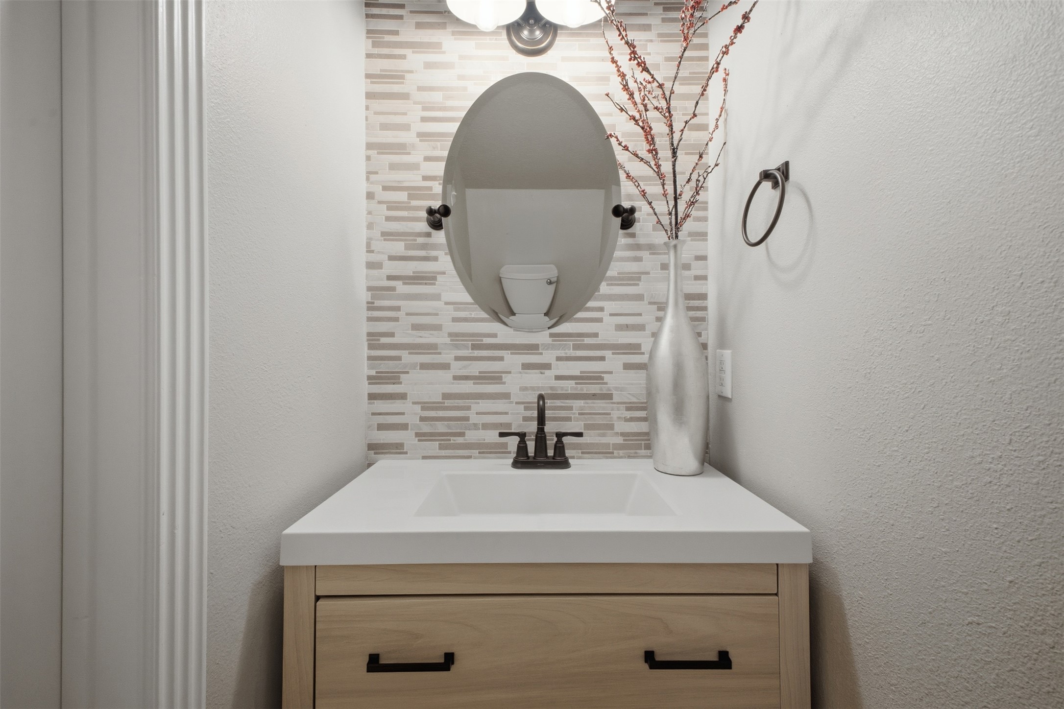 12710 Aries Loop Willis, TX 77318 - Photo 6 of 40 The bathroom features a vanity with a light wood finish, a white countertop, and a dark bronze faucet
