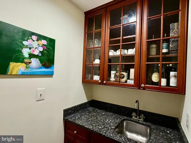 a living room with furniture a fireplace and a floor to ceiling window