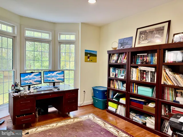 a kitchen with granite countertop a stove a sink a dining table and chairs