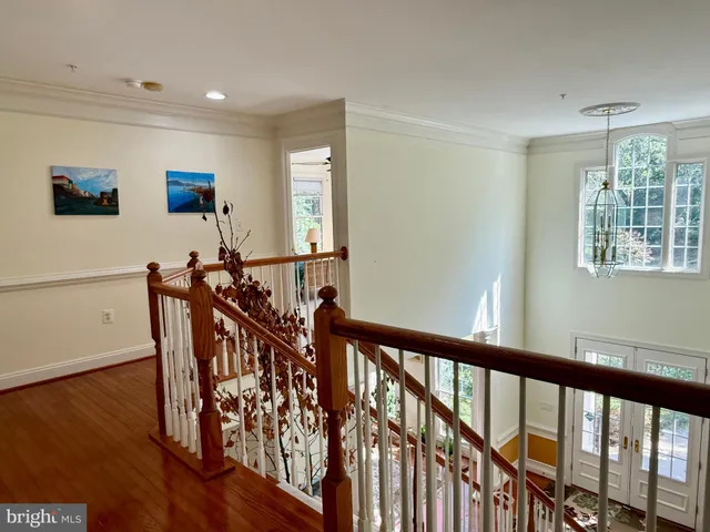 a spacious bedroom with a bed and a flat screen tv